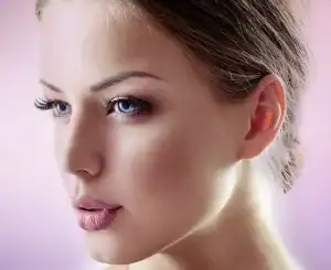 Close-up of a young woman's clear, youthful skin and natural beauty with flawless makeup.