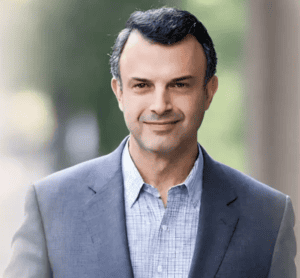 Professional male dentist in business suit, smiling outdoors, emphasizing dental health and confidence.